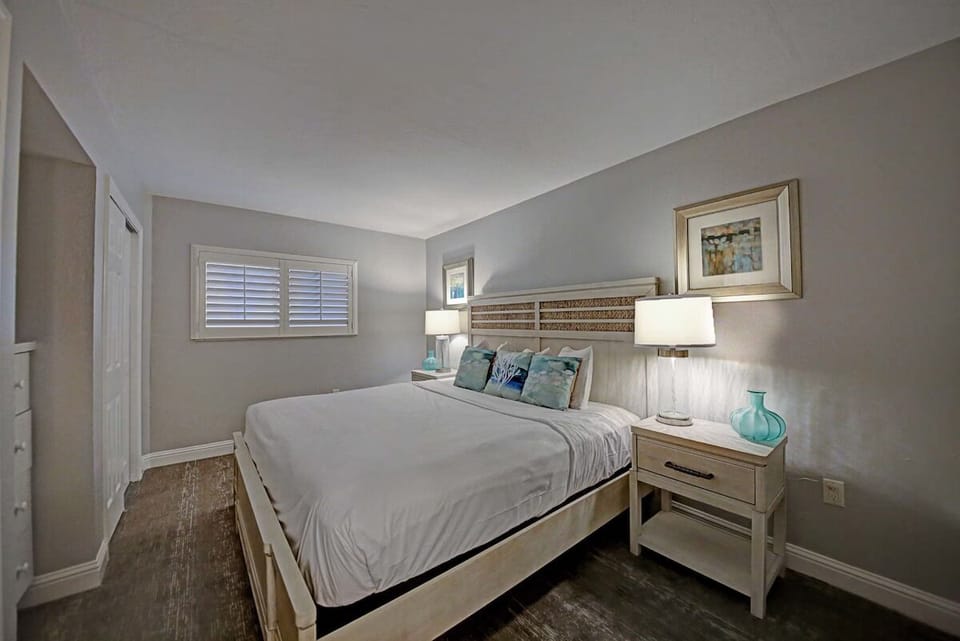 Unwind in crisp linens and a calm, cozy bedroom.