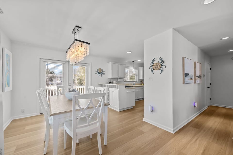 Spacious open layout with dining area, kitchen, and hallway leading to bedroom