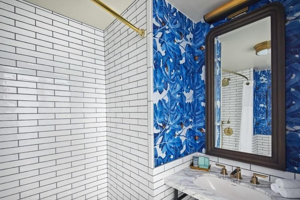 Get ready at a marble vanity with glowing designer lighting.