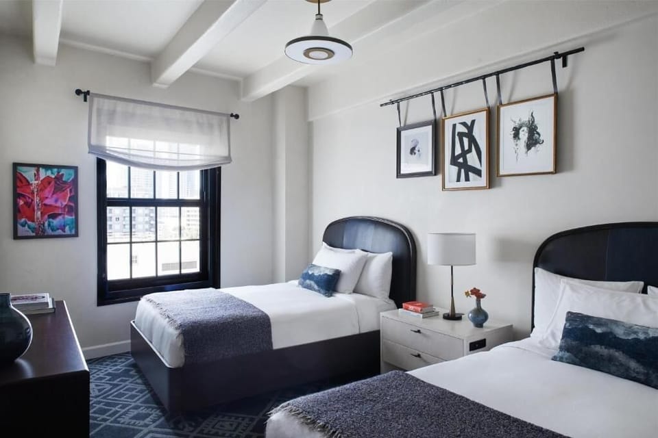 Settle in with two comfy beds and bright city light.