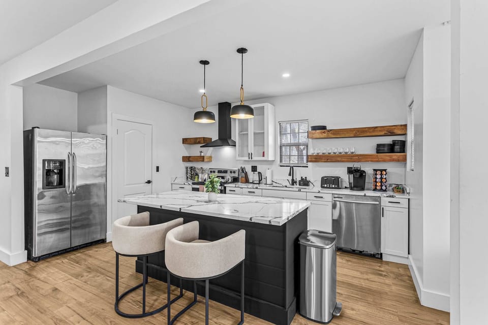 A spacious and well-lit kitchen with top-of-the-line appliances, perfect for preparing anything from quick bites to gourmet meals.