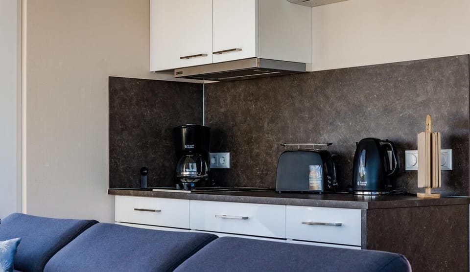 Modern Kitchen with Coffee Machine and Kettles