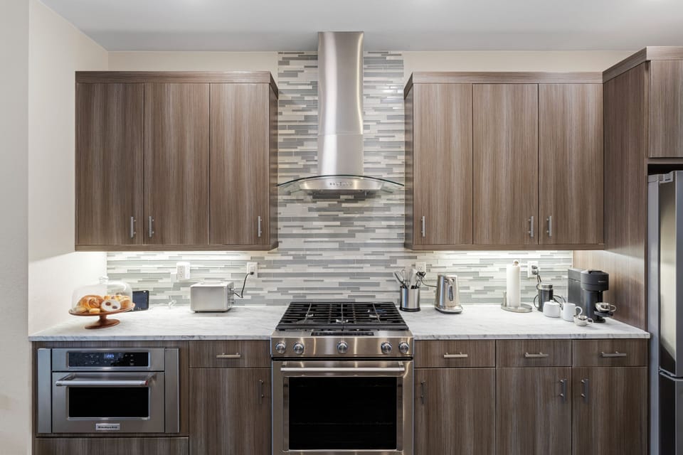 Your fully equipped kitchen features sleek appliances and ample counter space for preparing memorable meals during your stay.