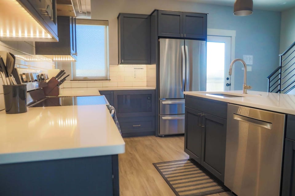The kitchen is fully stocked, has stunning granite counter tops, new appliances, and a tucked away coffee and wet bar.