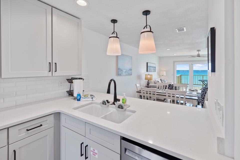 Your bright kitchen opens to a dining area and living room with stunning oceanfront views—perfect for preparing meals while soaking in the scenery.