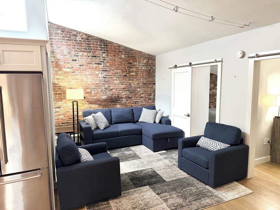 Large living room with exposed brick. 