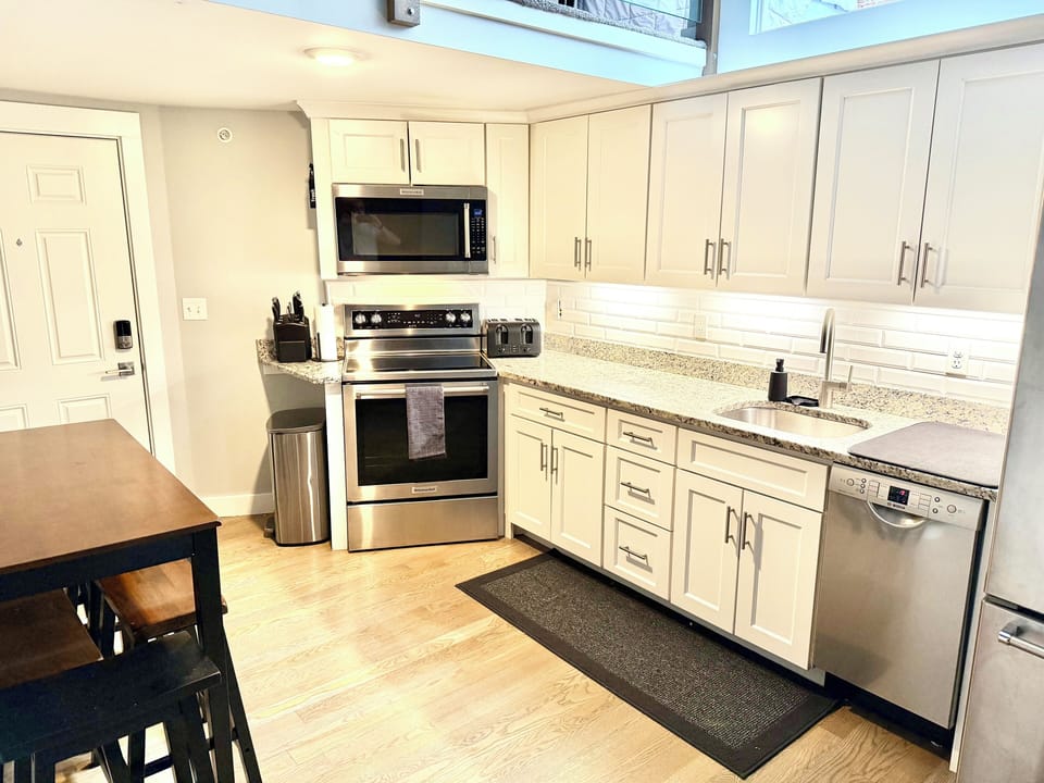 Full sized kitchen with all silverware, pots, pans, and other cooking equipment.