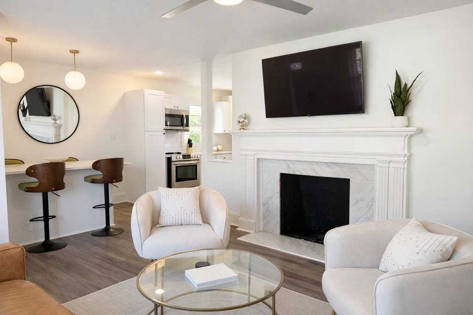 Open, calm space. Soft whites, warm wood, Smart TV, unwind.