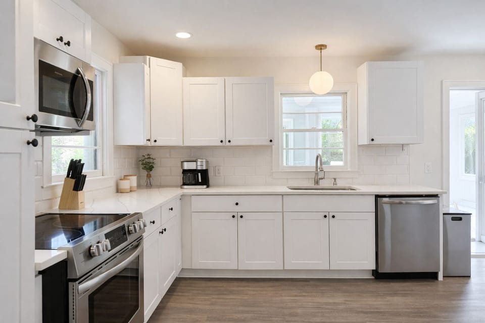 Bright, stocked kitchen. Stainless, coffee, dishwasher. Calm, modern vibe.