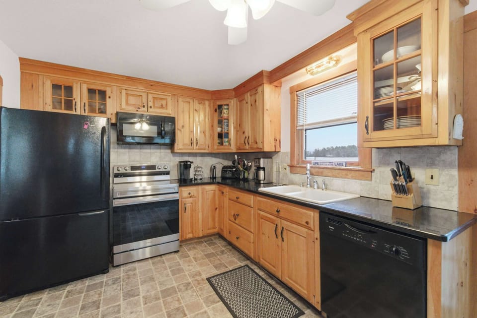 Warm knotty pine cabinetry and a full appliance lineup make this a kitchen that can handle a real family meal.