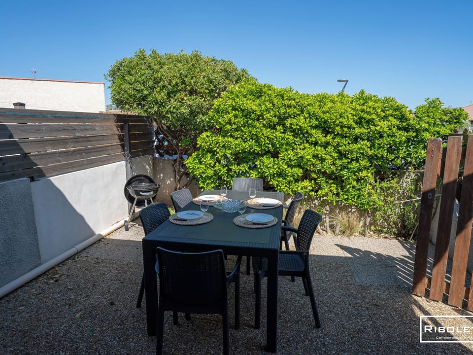 Private patio with furniture and a barbecue