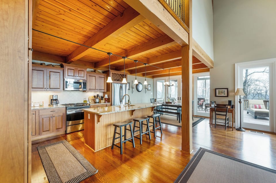 Kitchen: Culinary dreams come true in this sunlit space with granite counters and scenic views!