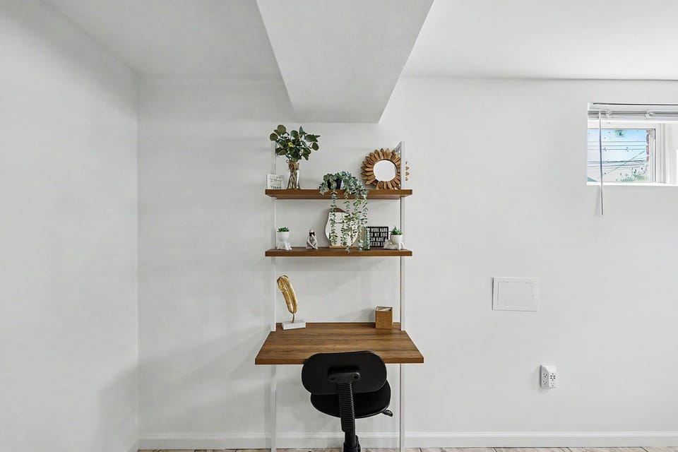 Bright, stylish work nook with floating shelves and a modern desk