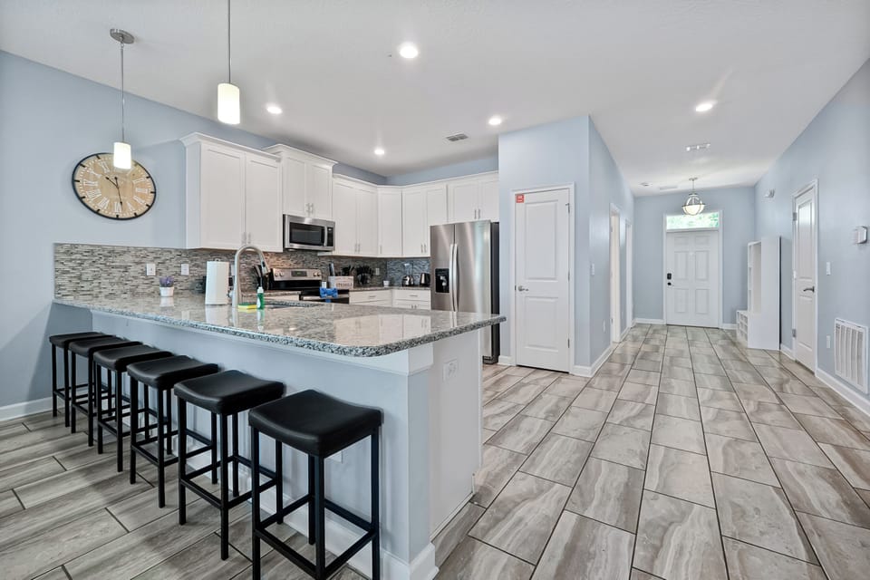 Bright and modern kitchen with sleek appliances and a stylish granite island