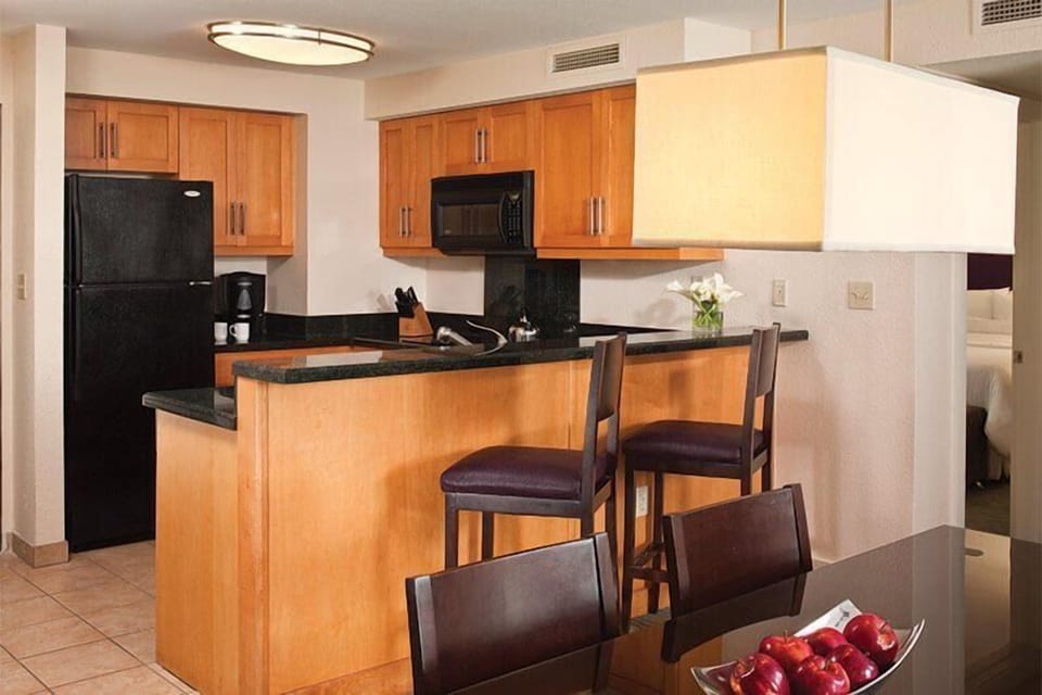 Warm open kitchen with breakfast bar and dining space