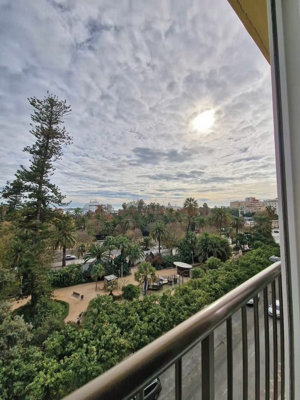 Balcony views overlooking lush green parkland.

