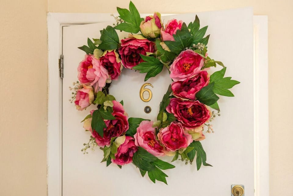 The lush peony wreath up close sets a joyful, welcoming tone from the moment you arrive.