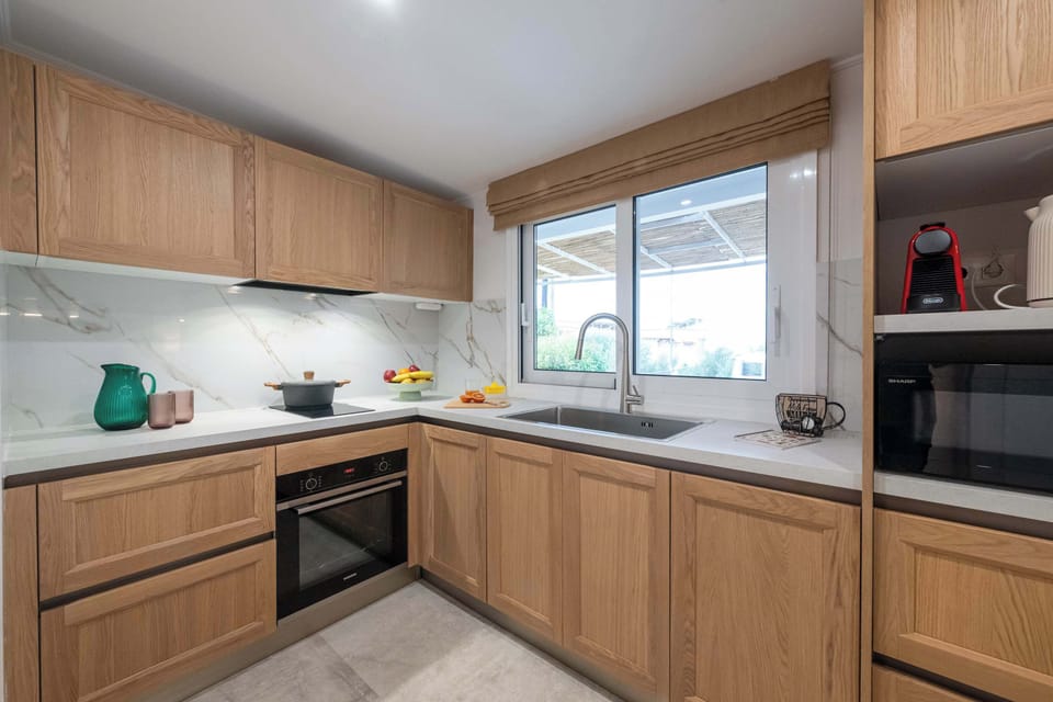 Spacious Kitchen with Natural Light and Wooden Finishes