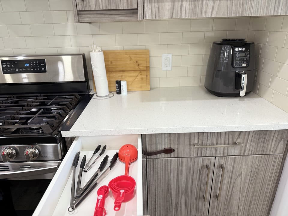Fully stocked kitchen with an air fryer—everything you need to cook and enjoy meals at home.