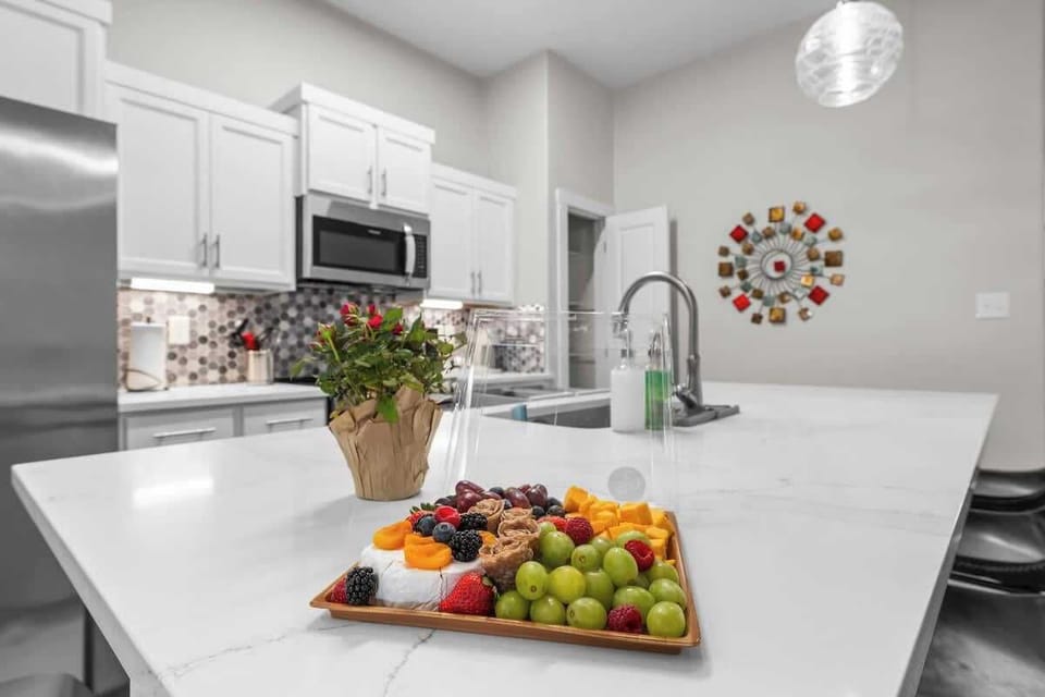 Explore this culinary masterpiece. Clean, simple lines, gorgeous backsplash, oversized kitchen island with seating for 4+ bonus of four seats at the table.

Stainless steel appliances and polished white countertops make this a perfect to entertain
