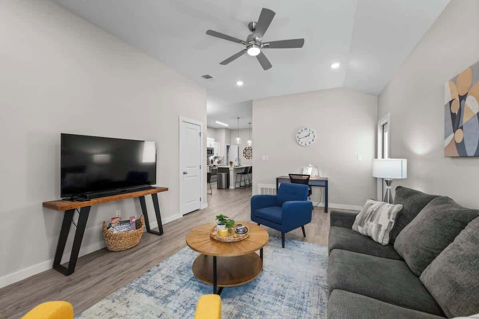 Instantly you're invited into this warm, bright vibrant living space. Relax on this comfortable sofa or sitting chairs after a long workday and enjoy watching the 4K smart TV with all your favorite apps