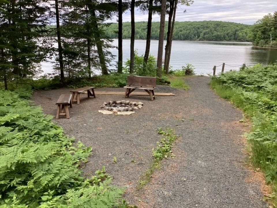 Gather around your private fire pit with lakefront seating, where evening conversations flow as naturally as the peaceful waters before you.