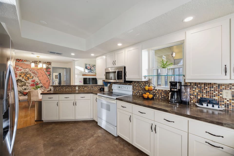 Spacious kitchen with oven, cooktop, microwave, fridge, and dishwasher