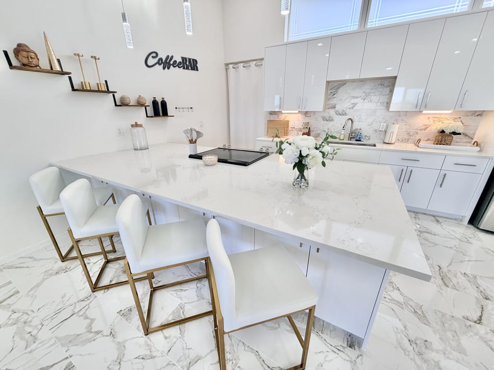 Sleek modern kitchen with spacious marble island and seating