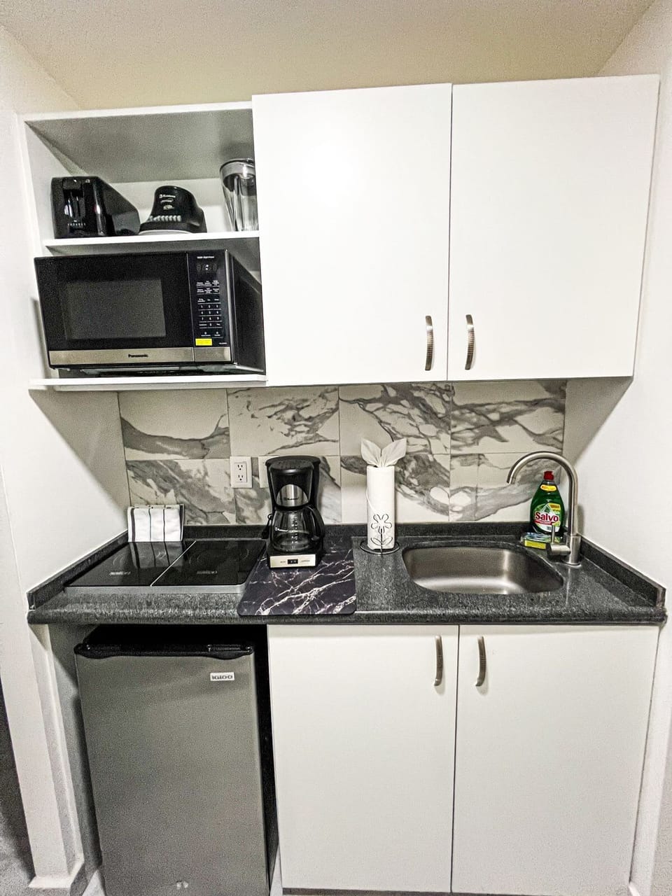 Compact kitchen w/ modern appliances, sleek cabinets & everything within reach