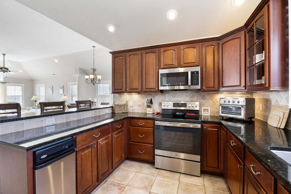 The gourmet kitchen is equipped with high-end GE appliances, perfect for preparing meals with ease.
