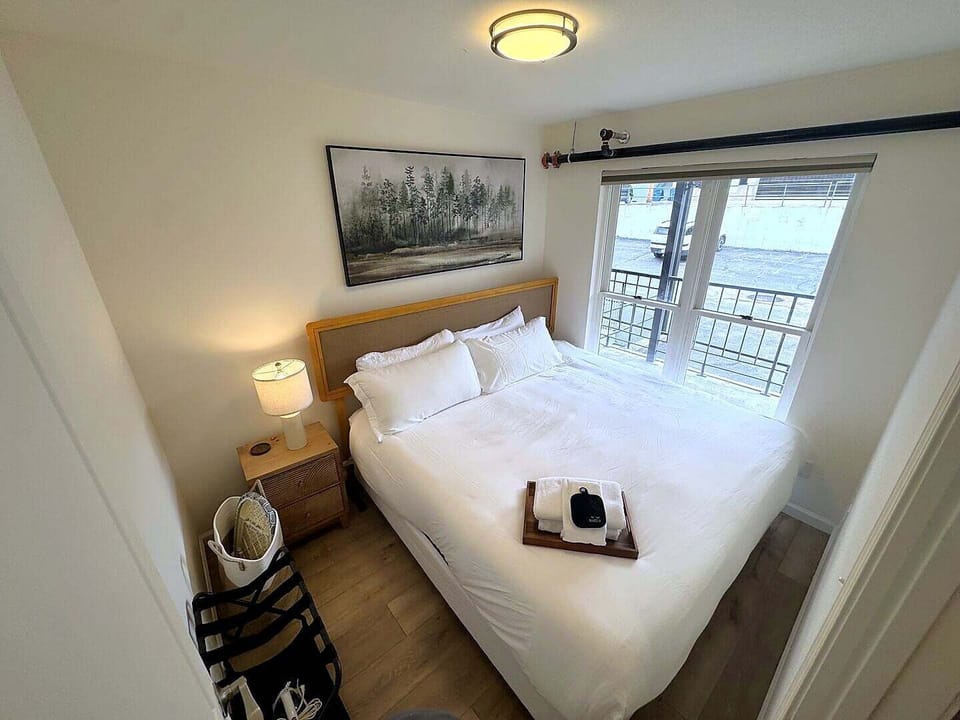 Interior hallway connecting the bedrooms and living area, decorated with framed mountain artwork.