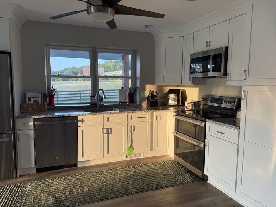 Cook, gather, and linger in a fully stocked kitchen overlooking rolling fields and the mountains  beyond. Featuring stainless steel appliances, generous prep space, a coffee station, and everything needed for everything from pancake breakfasts to holiday 