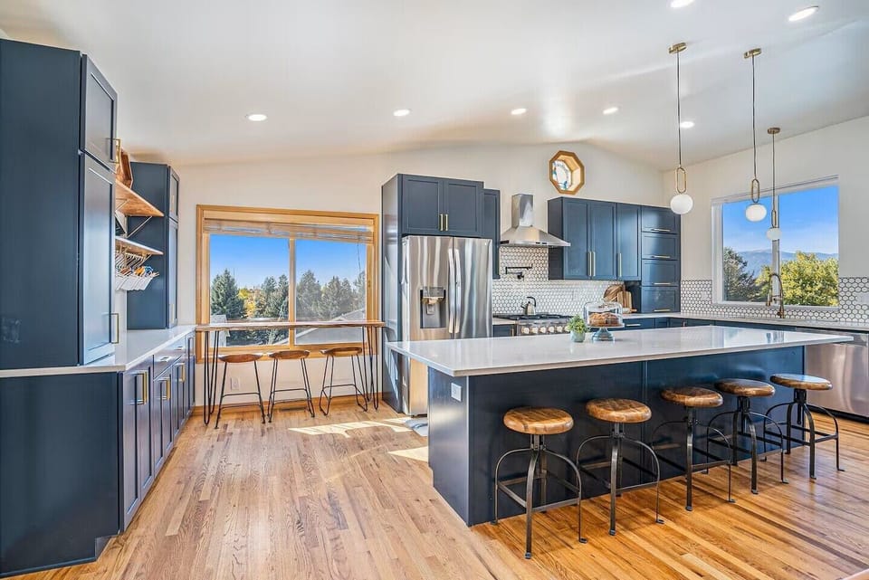 Upgraded kitchen with 6 burner stove, oversized island with extra seating, window view seating, and stainless steel appliances.  Kitchen window with glorious window view of Pikes Peak.