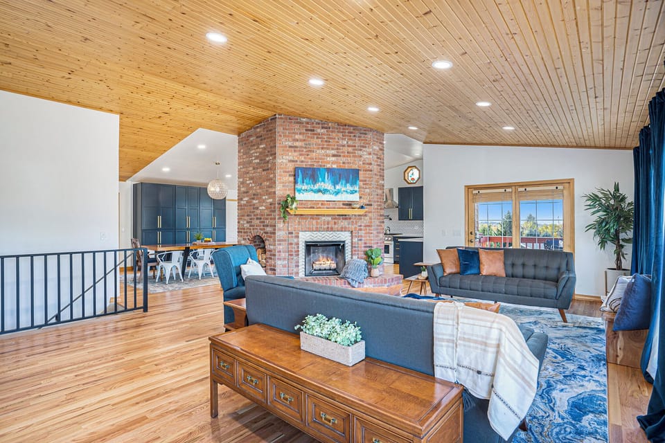 Huge cozy living space with fireplace and views of Pikes Peak. Great for family games or enjoying the afternoon sun.