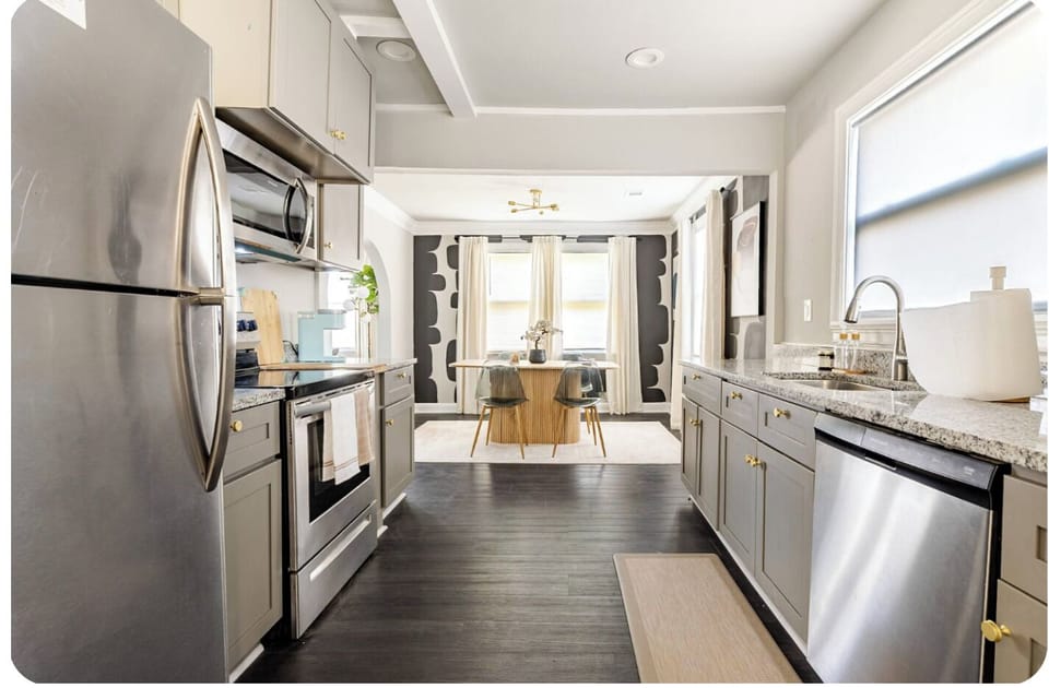 Modern kitchen, spacious for cooking and gathering with dining views.

