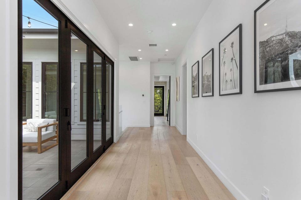 A gallery-style hallway that connects the home with clarity, light, and architectural flow