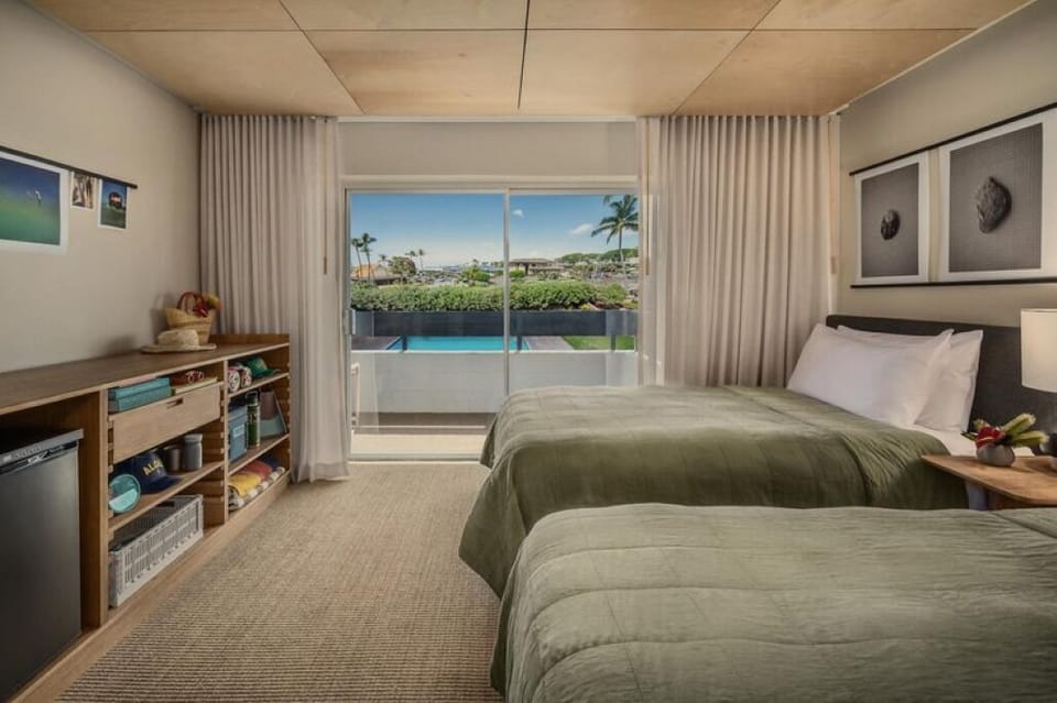Settle into twin beds and gaze out to tropical scenery.