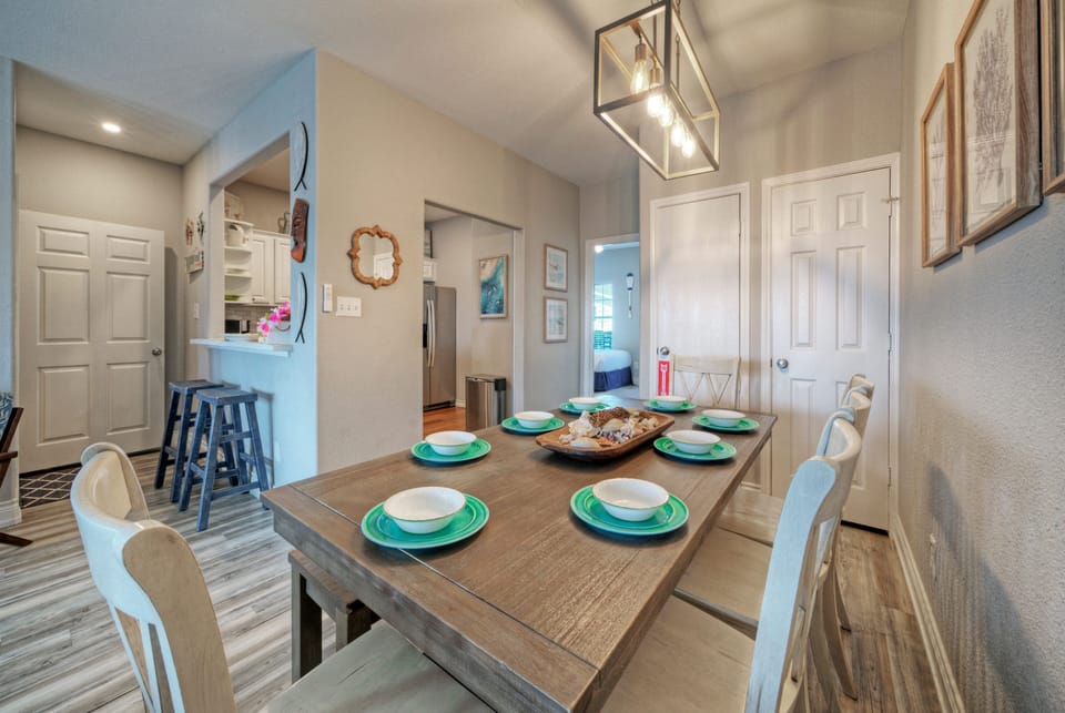 Coastal dining‑and‑living space with a set table, soft seating, and relaxed Lowcountry charm throughout.