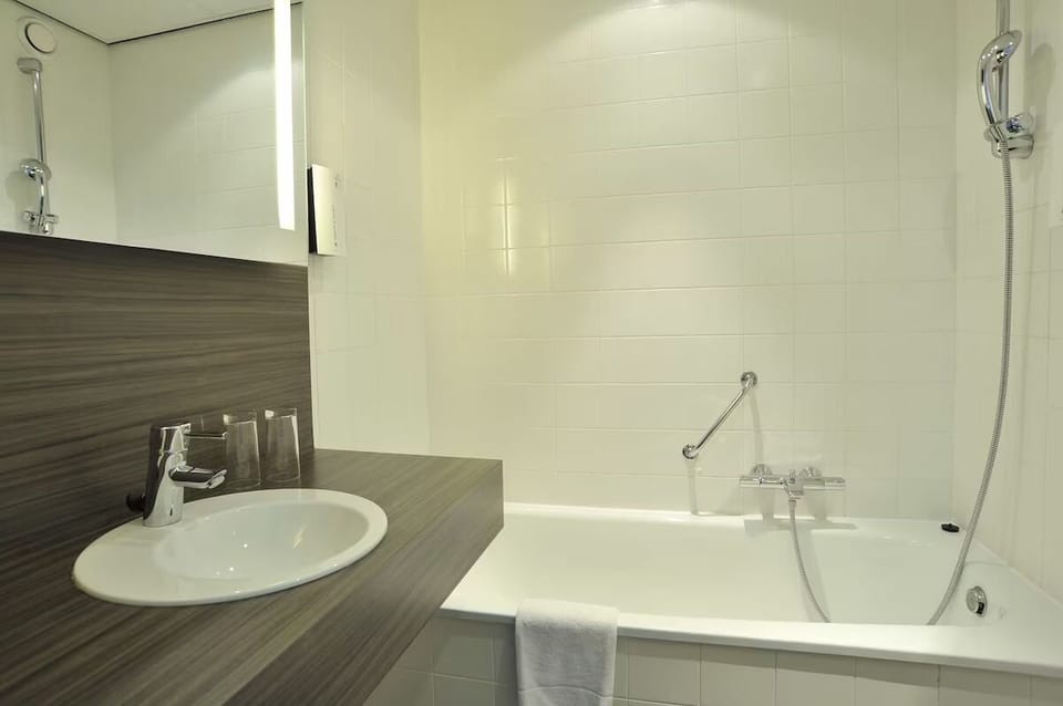 Soak and reset in a clean tub with bright vanity.