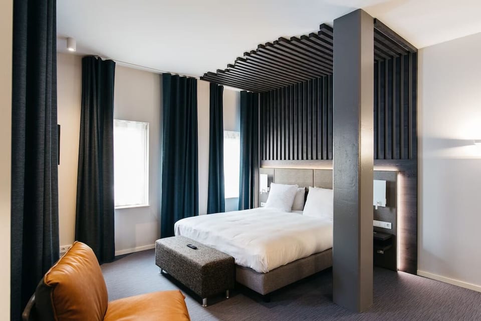 Recharge in a designer room with dramatic, cozy lighting.