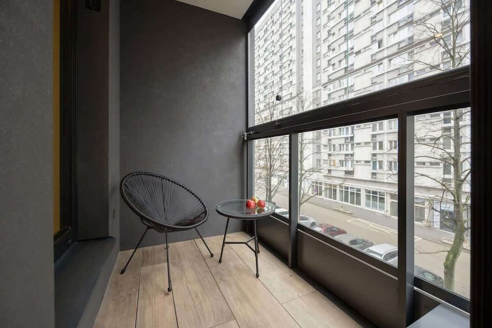 Cozy balcony with a city view, and comfortable chair.