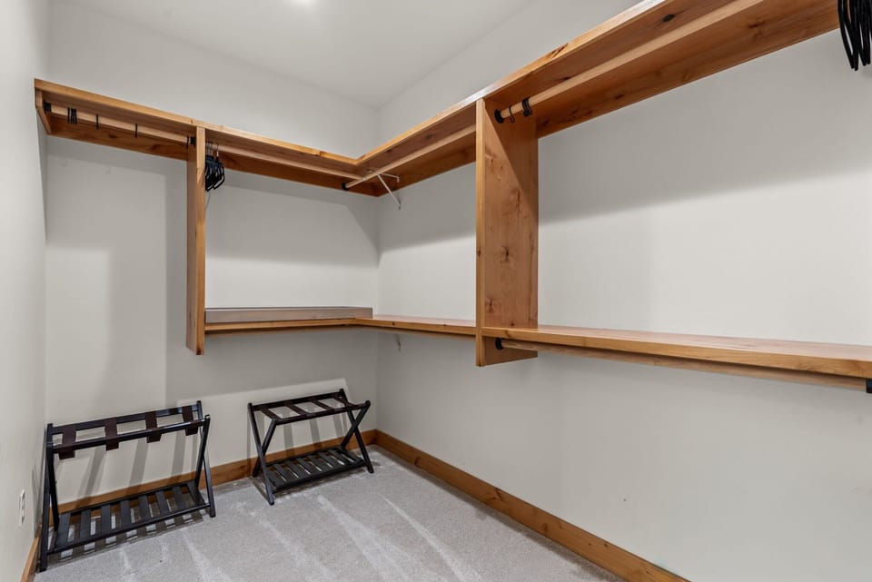 Your walk-in closet features custom cedar shelving and hanging rods, with convenient luggage racks for easy unpacking.