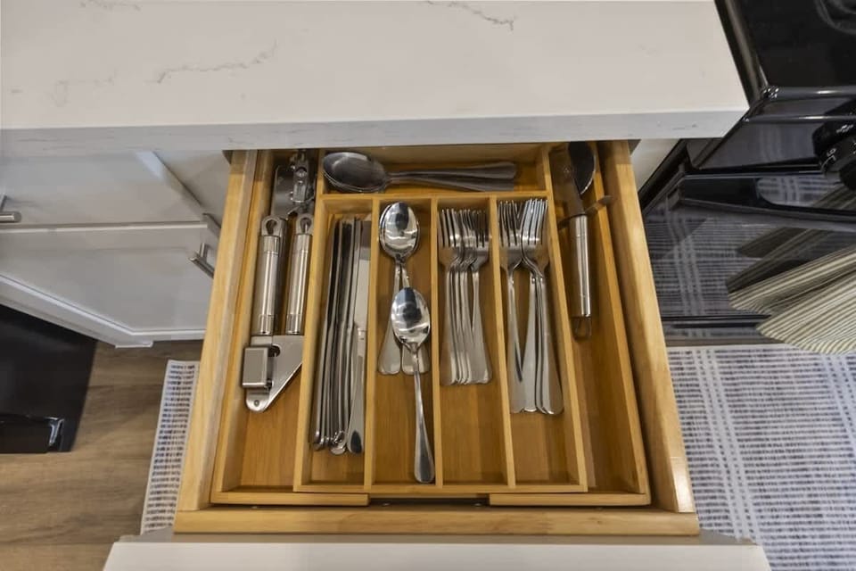 Fully stocked kitchen with dishes, glassware, and dinnerware for group meals.