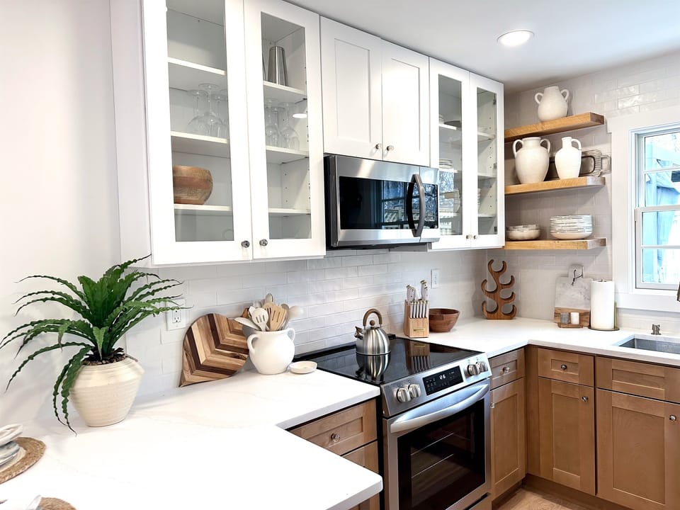 The kitchen features all new cabinets, appliances, dishes, and kitchenware