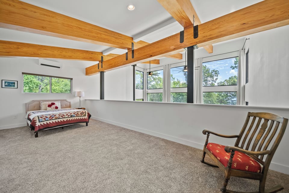 sleeping loft has 2 queen beds and its own bathroom