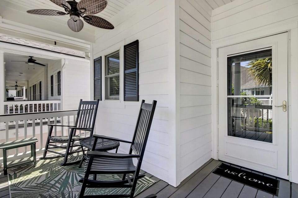 Settle into your private porch with rocking chairs and tropical breezes, where morning coffee tastes better under the ceiling fan.