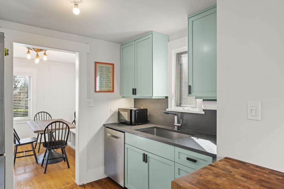 Bright and open, the kitchen flows naturally into the living and dining areas, creating an inviting setting for both gatherings and everyday living.