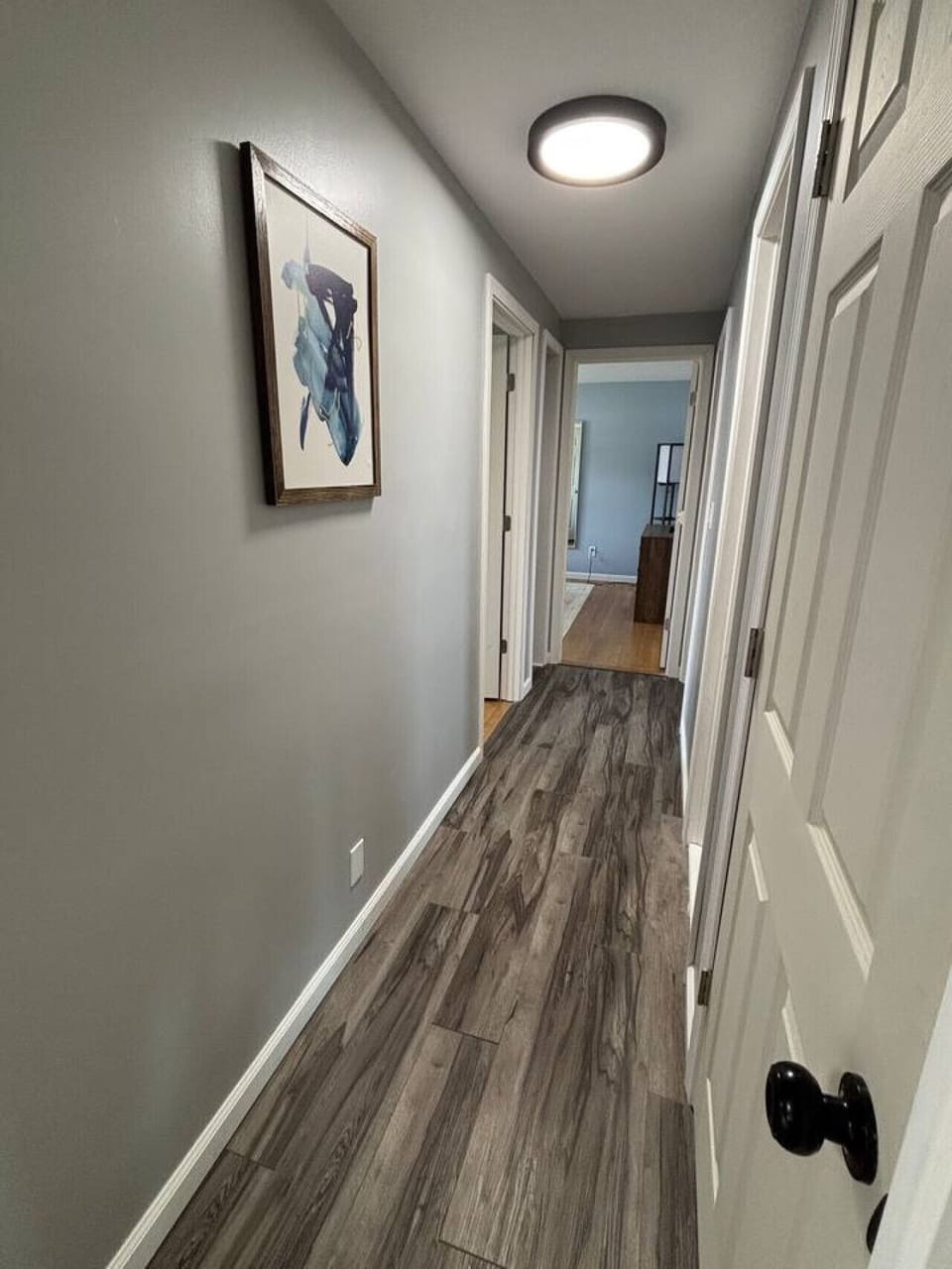 Hallway connects living room to the three bedrooms
