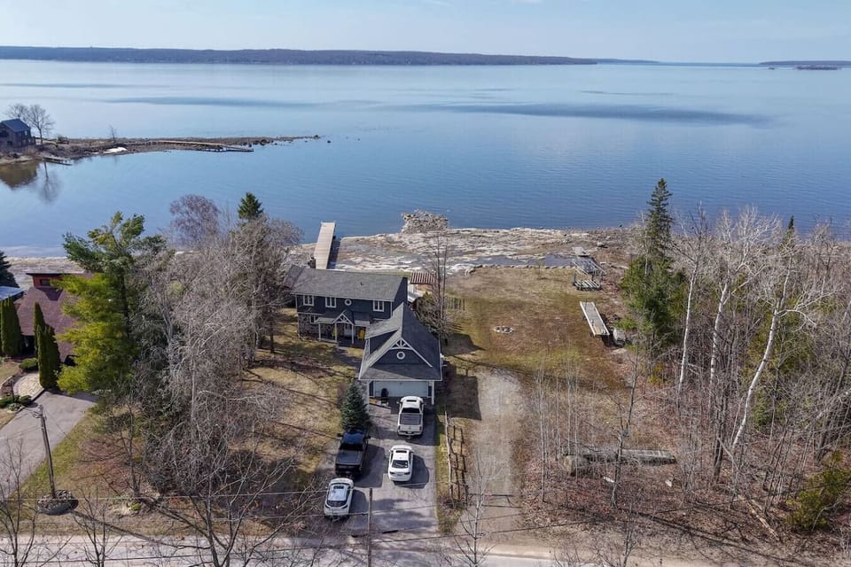 Exterior view of cottage and lake