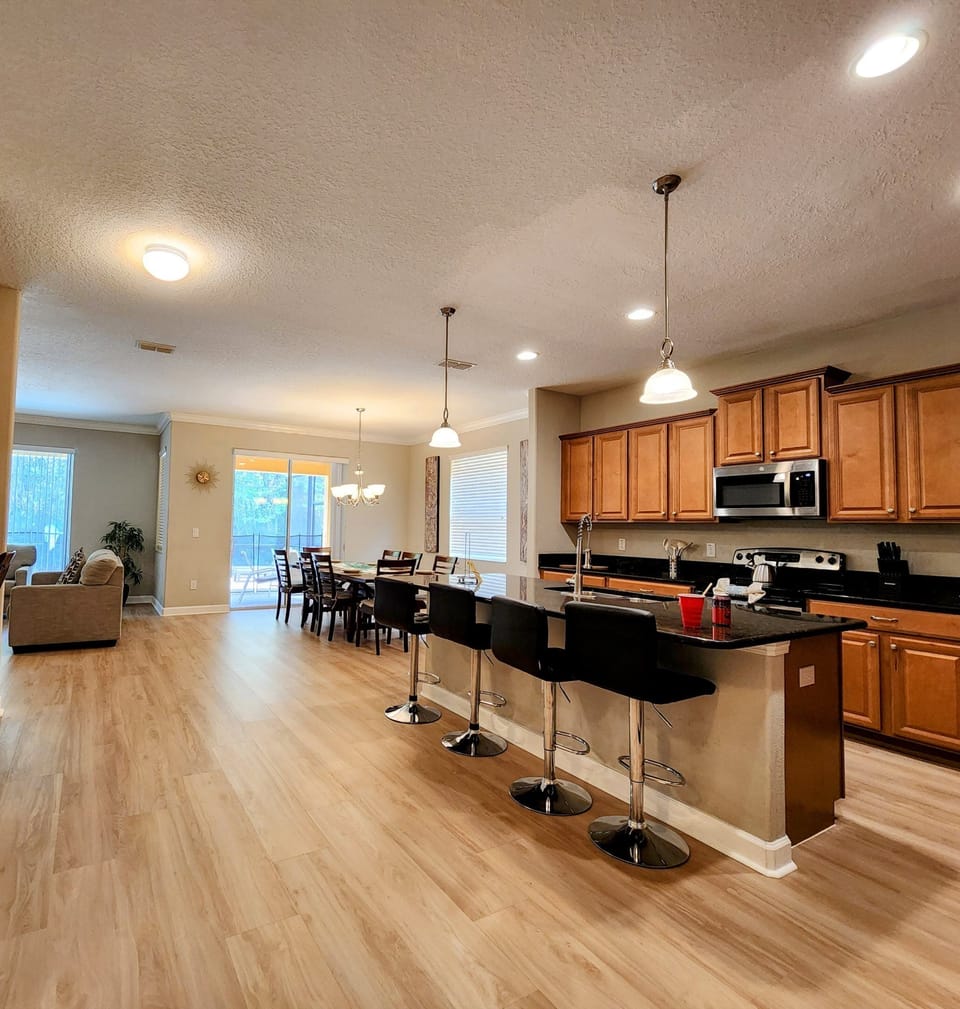 KITCHEN:  Overlooking Family Room and Dining Room with Direct Access to Patio